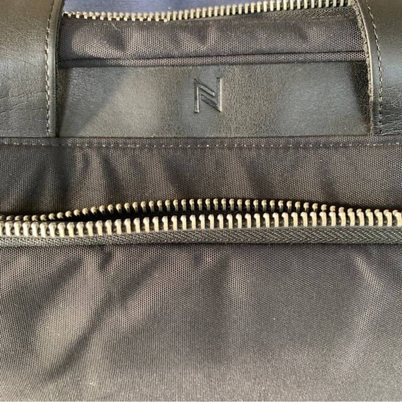 Black Travel Bag with Structured Design and Metal Feet - Picture 12 of 16